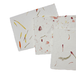 Four sheets of handmade seed paper with colorful botanical inclusions such as leaves and flower petals, displayed on a white background.