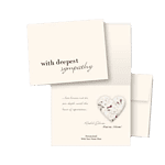 A sympathy card with the words "with deepest sympathy" on the front, made of seed paper, accompanied by another card and a heart-shaped object, all placed on a plain background.
